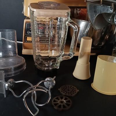 LOT 154: Oster Foodcrafter Regency Kitchen Center and Accessories along with a Hand Crank Food Processor