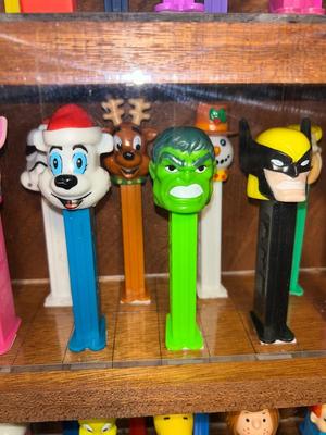 DISPLAY CASE FULL OF PEZ DISPENSERS