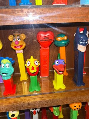 DISPLAY CASE FULL OF PEZ DISPENSERS