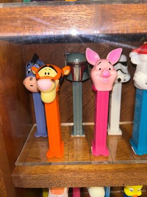 DISPLAY CASE FULL OF PEZ DISPENSERS
