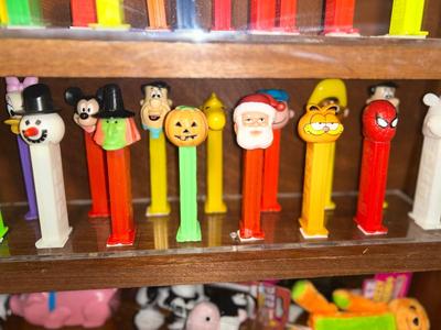 DISPLAY CASE FULL OF PEZ DISPENSERS