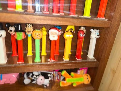 DISPLAY CASE FULL OF PEZ DISPENSERS