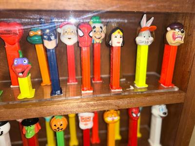 DISPLAY CASE FULL OF PEZ DISPENSERS