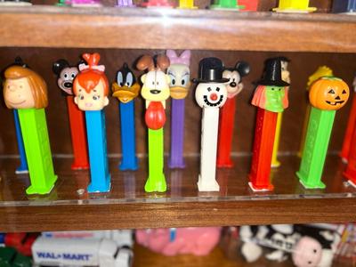 DISPLAY CASE FULL OF PEZ DISPENSERS