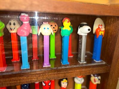 DISPLAY CASE FULL OF PEZ DISPENSERS