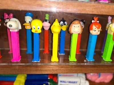 DISPLAY CASE FULL OF PEZ DISPENSERS