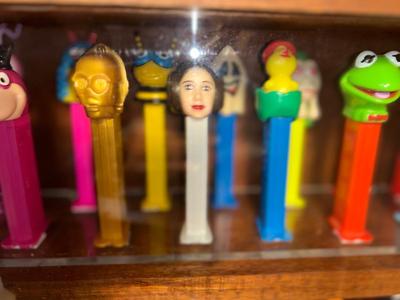 DISPLAY CASE FULL OF PEZ DISPENSERS