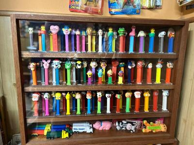 DISPLAY CASE FULL OF PEZ DISPENSERS