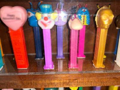 DISPLAY CASE FULL OF PEZ DISPENSERS