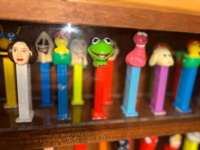 DISPLAY CASE FULL OF PEZ DISPENSERS