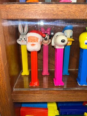 DISPLAY CASE FULL OF PEZ DISPENSERS