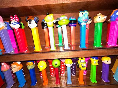 CLEVERLY MADE DISPLAY CASE FILLED WITH PEZ DISPENSERS