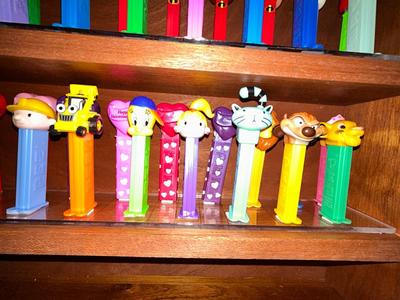 CLEVERLY MADE DISPLAY CASE FILLED WITH PEZ DISPENSERS
