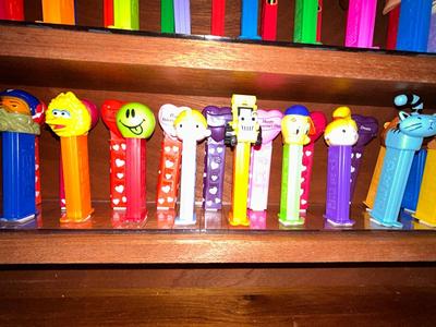 CLEVERLY MADE DISPLAY CASE FILLED WITH PEZ DISPENSERS