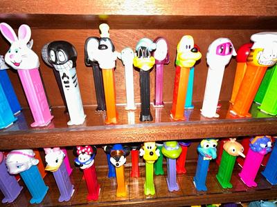 CLEVERLY MADE DISPLAY CASE FILLED WITH PEZ DISPENSERS