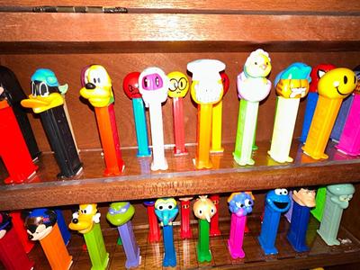 CLEVERLY MADE DISPLAY CASE FILLED WITH PEZ DISPENSERS