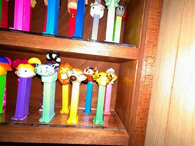 CLEVERLY MADE DISPLAY CASE FILLED WITH PEZ DISPENSERS
