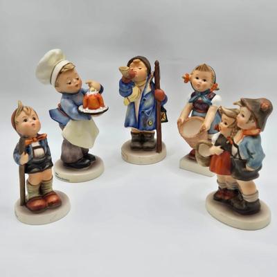 LOT 31D: Goebel Hummel Figurines Including Night Watchman, Little Pastry Cook, Little Hiker, Surprise AKA Hansel & Gretel, and Little...
