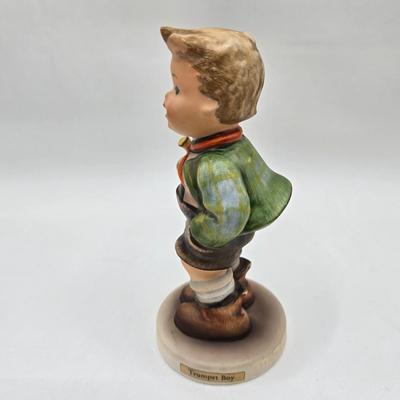 LOT 36D: Goebel Hummel Figurines Including Telling Her Secret, Trumpet Boy, Singing Lessons, Sensitive Hunter, and Merry Wanderer