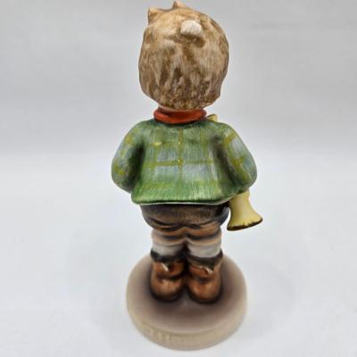 LOT 36D: Goebel Hummel Figurines Including Telling Her Secret, Trumpet Boy, Singing Lessons, Sensitive Hunter, and Merry Wanderer
