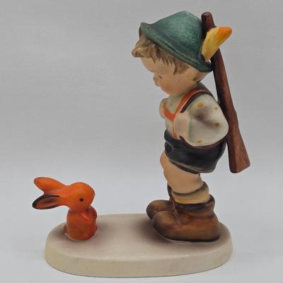 LOT 36D: Goebel Hummel Figurines Including Telling Her Secret, Trumpet Boy, Singing Lessons, Sensitive Hunter, and Merry Wanderer