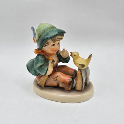 LOT 36D: Goebel Hummel Figurines Including Telling Her Secret, Trumpet Boy, Singing Lessons, Sensitive Hunter, and Merry Wanderer