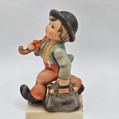 LOT 36D: Goebel Hummel Figurines Including Telling Her Secret, Trumpet Boy, Singing Lessons, Sensitive Hunter, and Merry Wanderer