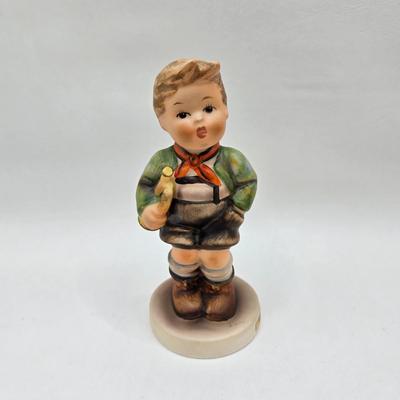 LOT 36D: Goebel Hummel Figurines Including Telling Her Secret, Trumpet Boy, Singing Lessons, Sensitive Hunter, and Merry Wanderer