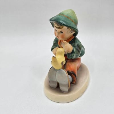 LOT 36D: Goebel Hummel Figurines Including Telling Her Secret, Trumpet Boy, Singing Lessons, Sensitive Hunter, and Merry Wanderer
