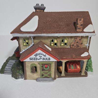 LOT 115X: Dept. 56 "J. Hudson Stoveworks" and " Bluebird Seed and Bulb" / with Original Boxes