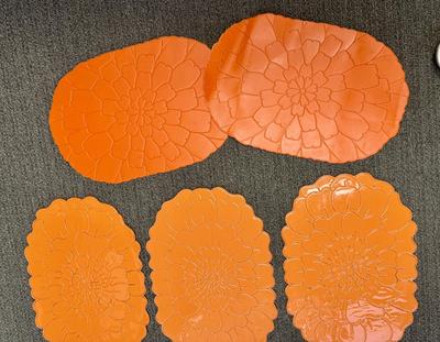 Lot of 8 bright orange plastic placemats - 2 are slightly different