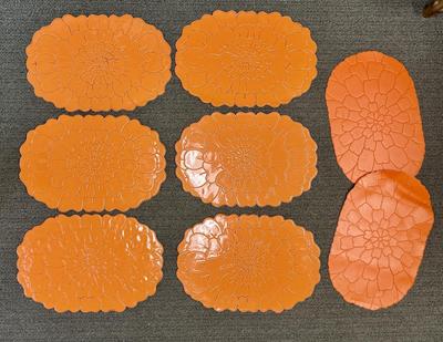 Lot of 8 bright orange plastic placemats - 2 are slightly different
