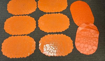 Lot of 8 bright orange plastic placemats - 2 are slightly different
