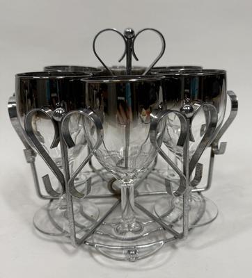 Sale Photo Thumbnail #1: In good condition except for some rust on the metal caddy and one glass has a chIp in base. See photos.