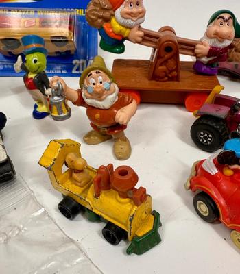 Sale Photo Thumbnail #28: (2) Mickey Mouse Pull Back toy 1988 
(1) Snoopy Die-cast Metal Train Avila Collectible 
(1) Disney ~ Snow White & The Seven Dwarfs - Mine Train Rail Car
(1) Matchbox Lesley Mod Tractor 1972 
(1) Donald Duck Policeman in. Patrol Car Pull-back toy
(1) New i