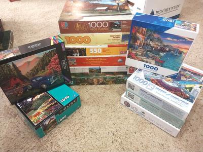 TWELVE PUZZLES MOST ARE 1000 PIECES