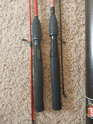 TWO SHAKESPEARE FISHING RODS IN TUBE HOLDER