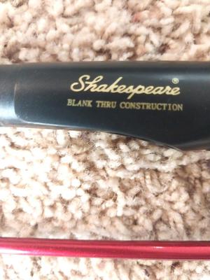 TWO SHAKESPEARE FISHING RODS IN TUBE HOLDER