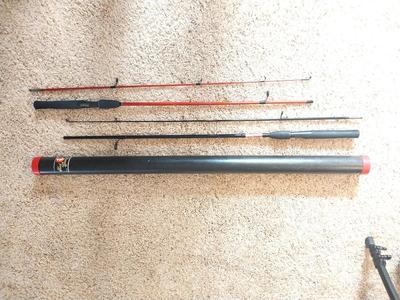 TWO SHAKESPEARE FISHING RODS IN TUBE HOLDER