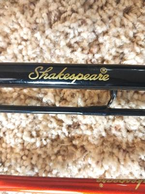 TWO SHAKESPEARE FISHING RODS IN TUBE HOLDER