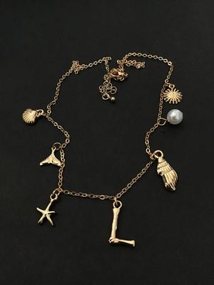 Cute gold tone sea themed charm necklace