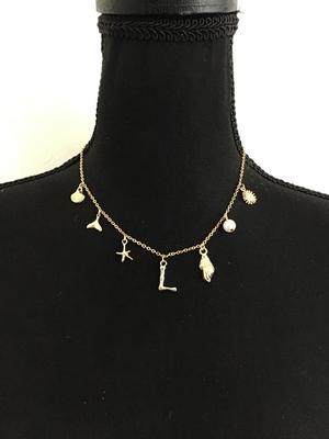 Cute gold tone sea themed charm necklace