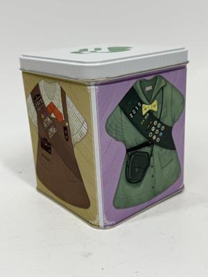 Sale Photo Thumbnail #590: Collectible Metal Tin with snap-down lid.  Images of 4 different Girl Scout uniforms. No dents or scratches.