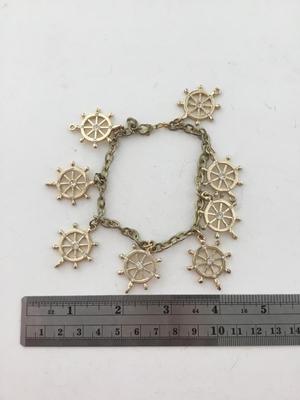 Gold tone wheel charm bracelet