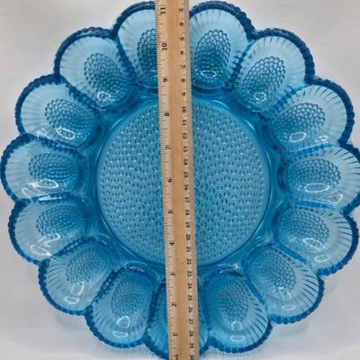LOT 131: Blue Glass Deviled Egg Plate, Lace Edge Clear Glass Pedestal Bowl, Fan Plate, Green and Amber Glass Lace & Dew Drop Cream...
