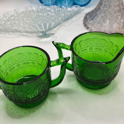 LOT 131: Blue Glass Deviled Egg Plate, Lace Edge Clear Glass Pedestal Bowl, Fan Plate, Green and Amber Glass Lace & Dew Drop Cream...