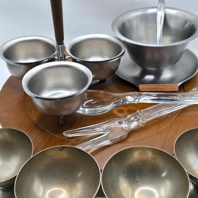 LOT 133: MCM Wooed Lazy Susan, Stainless Steel Condiment Server, Gravy Boat, 4 Silver Plated Dessert Cups and Glass Salad Serving Spoon...