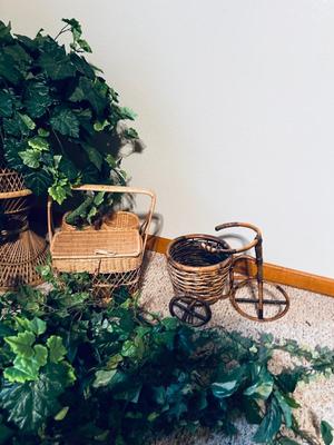FAUX FOLIAGE AND ACCOMPANYING WICKER ITEMS