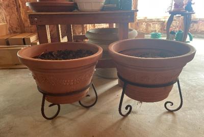 Large resin planters on metal stands