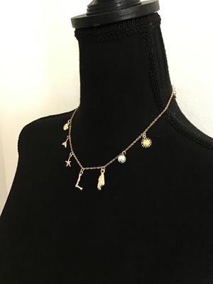 Cute gold tone sea themed charm necklace